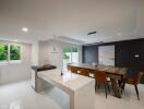 Modern kitchen and dining area with island and large table