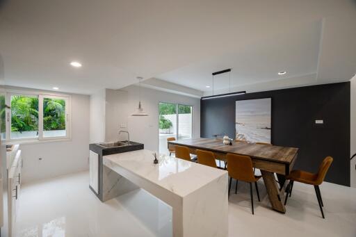 Modern kitchen and dining area with island and large table