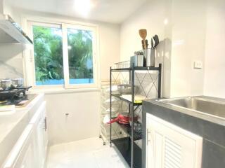 Bright kitchen with utensils and storage rack