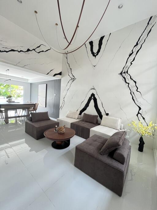 Modern living room with abstract wall design and comfortable seating