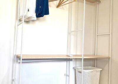 Spacious closet with hanging and shelf storage