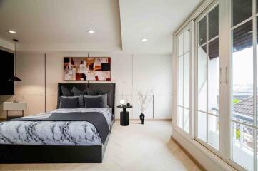 Modern bedroom with large windows and contemporary decor