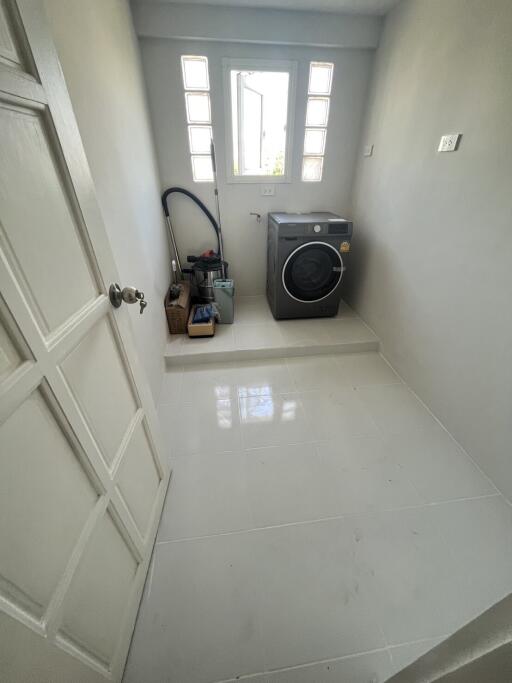 Laundry room with washer and storage area