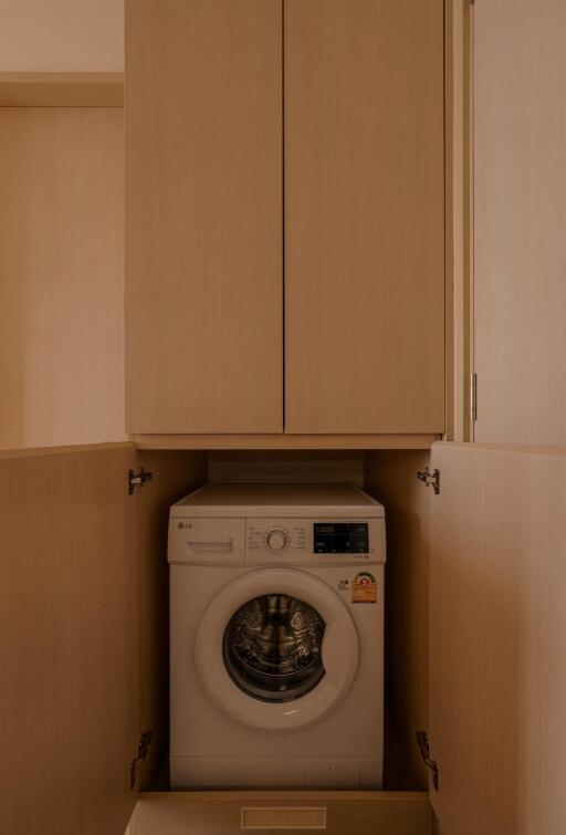 Compact laundry setup with modern appliances and storage