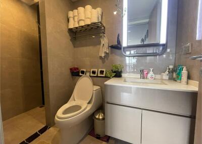 Modern bathroom with vanity and toilet.