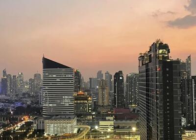 View of modern city skyline at sunset