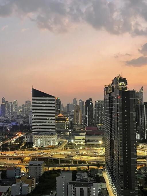 View of modern city skyline at sunset