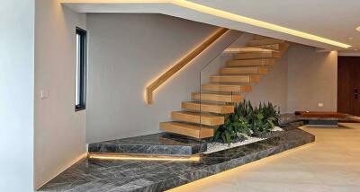 Modern staircase with glass railing and built-in planter