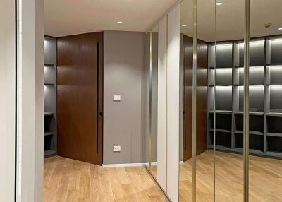 Hallway with wooden flooring and mirrors