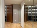 Hallway with wooden flooring and mirrors