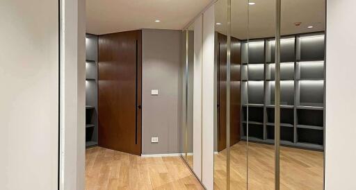 Hallway with wooden flooring and mirrors