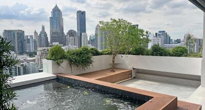 Modern rooftop terrace with a small pool and city view