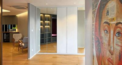 Contemporary interior living space with wall art and mirrored wardrobe