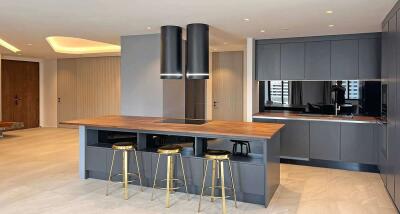 Modern kitchen with a wooden island and bar stools