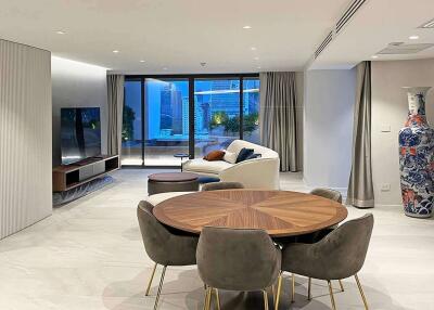 Modern living and dining area with large windows