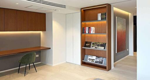 Modern living area with built-in bookcase and study desk