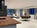 Modern open plan living area with kitchen, dining, and seating spaces