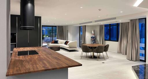 Modern open plan living area with kitchen, dining, and seating spaces