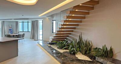 Modern living space with floating staircase and indoor garden