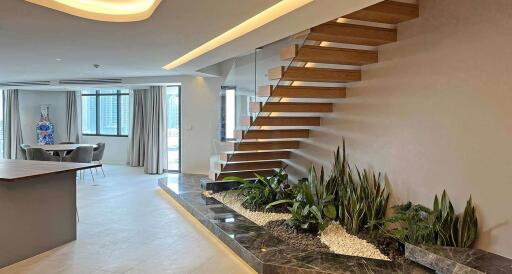 Modern living space with floating staircase and indoor garden