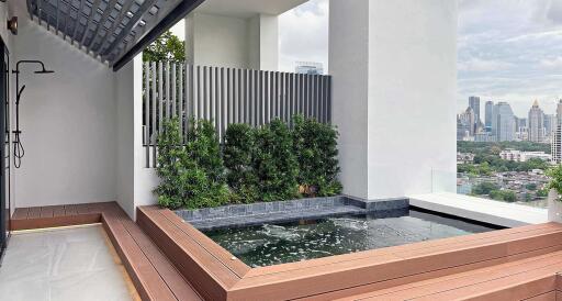 Balcony with small pool and city view