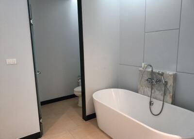 Modern bathroom with a bathtub and toilet