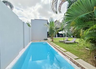 Outdoor pool area with lounge chairs