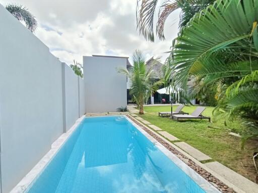 Outdoor pool area with lounge chairs