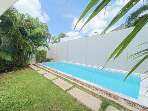 Private swimming pool with surrounding garden area