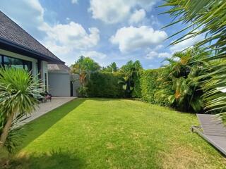 Spacious backyard with lush greenery and well-maintained lawn