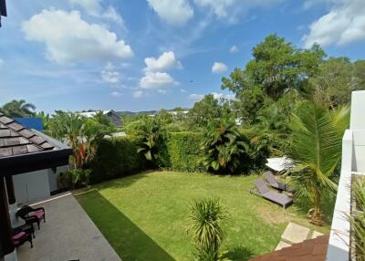 Spacious outdoor backyard with well-maintained lawn and various plants