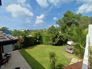 Spacious outdoor backyard with well-maintained lawn and various plants