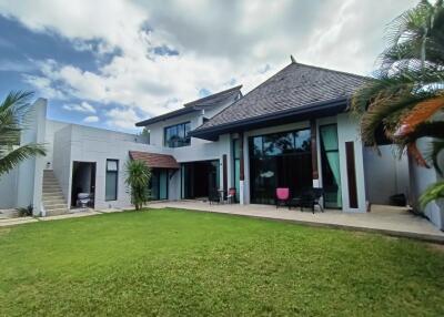 Modern house exterior with large windows and lawn