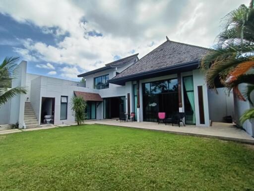 Modern house exterior with large windows and lawn