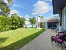 Spacious backyard with patio seating and lush greenery