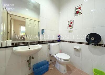 Clean bathroom with white tiles and a wall-mounted sink