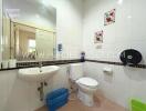 Clean bathroom with white tiles and a wall-mounted sink