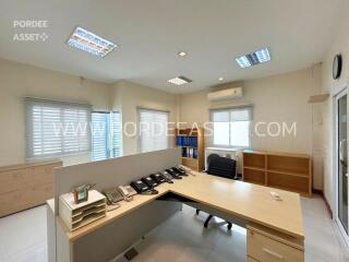 Well-lit office space with desk and multiple phones