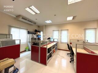 Modern office space with cubicles and shelving