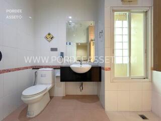 Modern bathroom with sink, toilet, and mirror