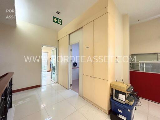 Interior view of a corridor with beige cabinets