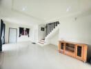 Spacious living room with modern interior and staircase