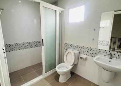 Modern bathroom with shower enclosure, toilet, and sink