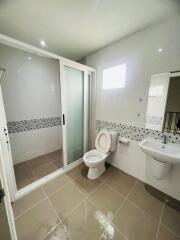 Modern bathroom with shower enclosure, toilet, and sink