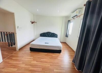 Spacious bedroom with wooden flooring