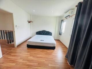 Spacious bedroom with wooden flooring