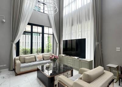 Spacious and elegant living room with high ceilings and large windows