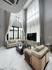 Spacious and elegant living room with high ceilings and large windows