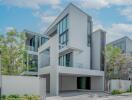 Modern multi-story residential building with large windows and private balconies