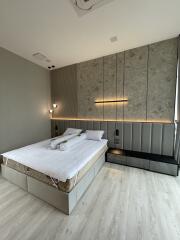 Modern bedroom with contemporary lighting and bedside tables